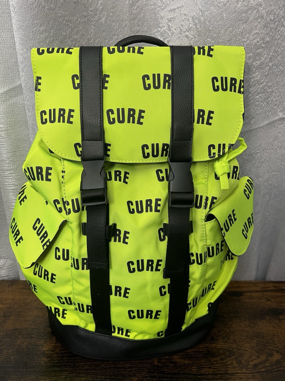 Green/Black CURE Logo Print Backpack Drawstring Buckle Adjustable Straps