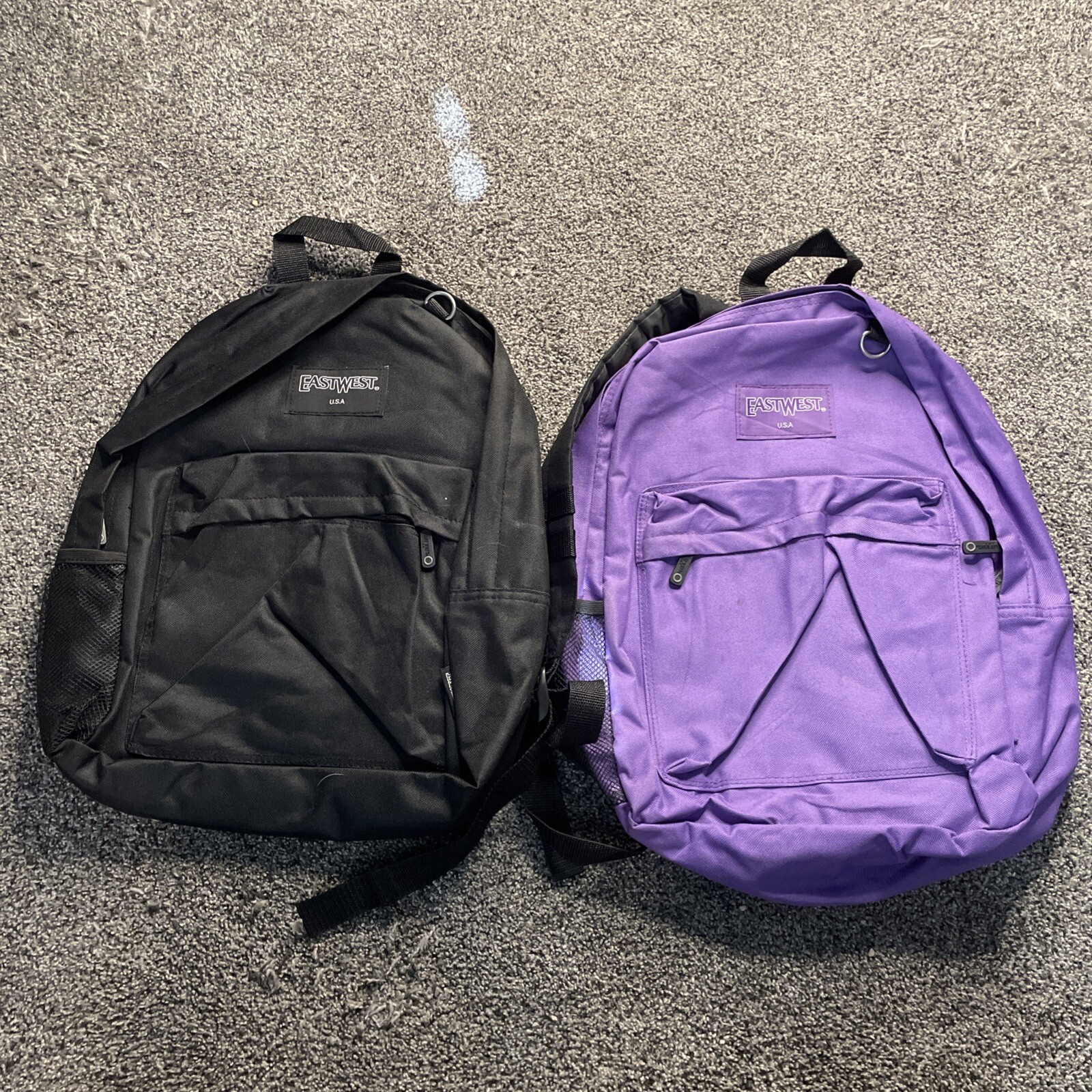 (2) EastWest East West Backpacks 1 Black 1 Purple Approx 15”x12” Canvas