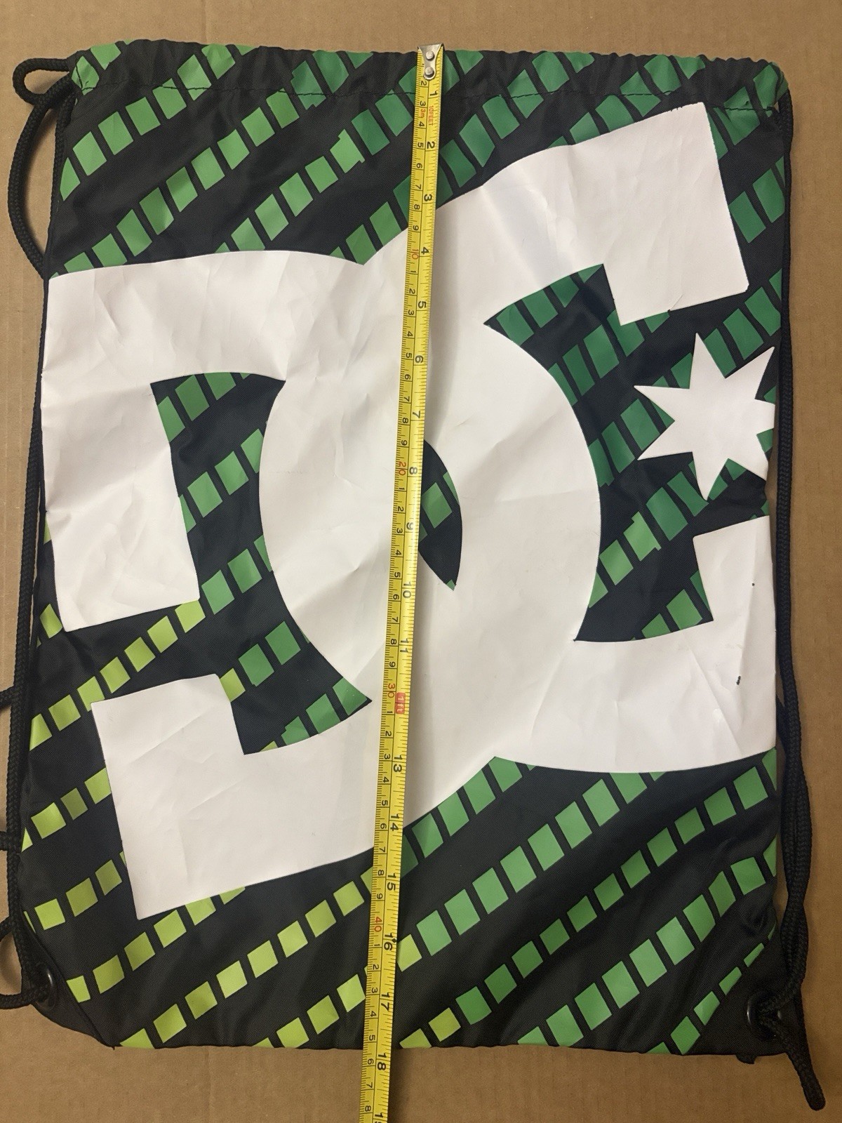 DC skate brand Simpski drawstring green with black and white dc logo backpack