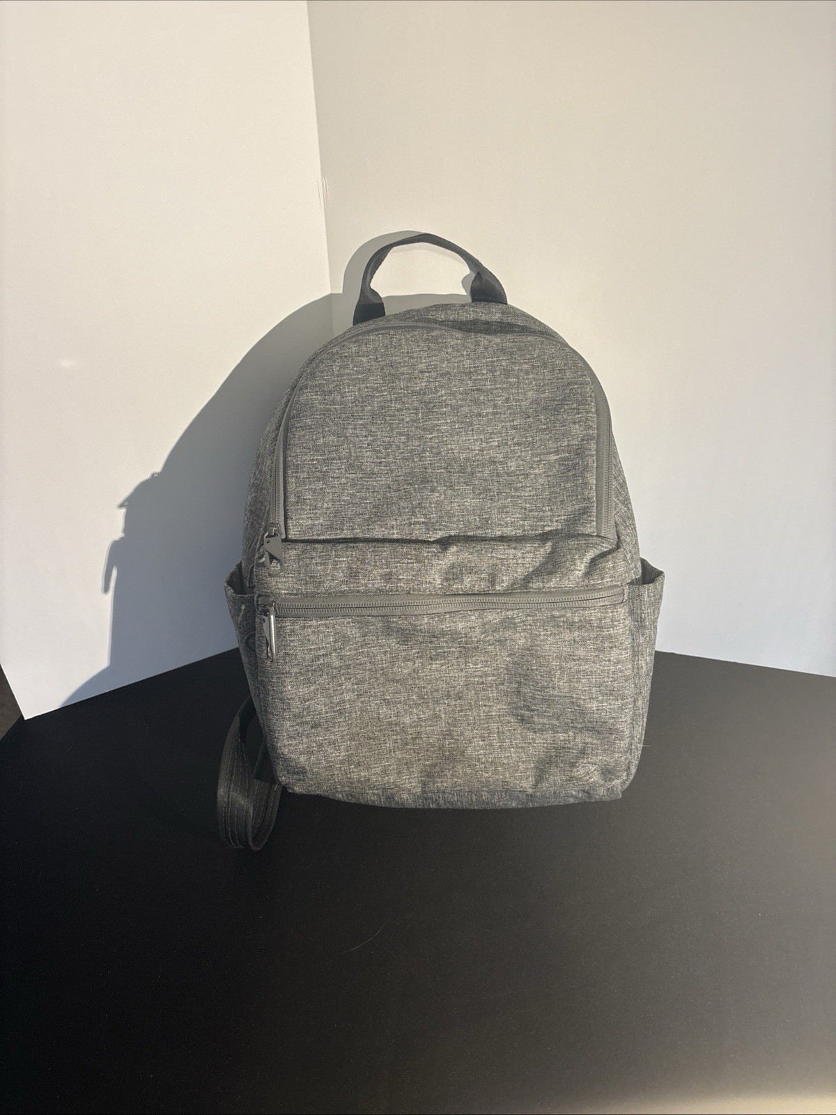 grey backpack 15” By 11”