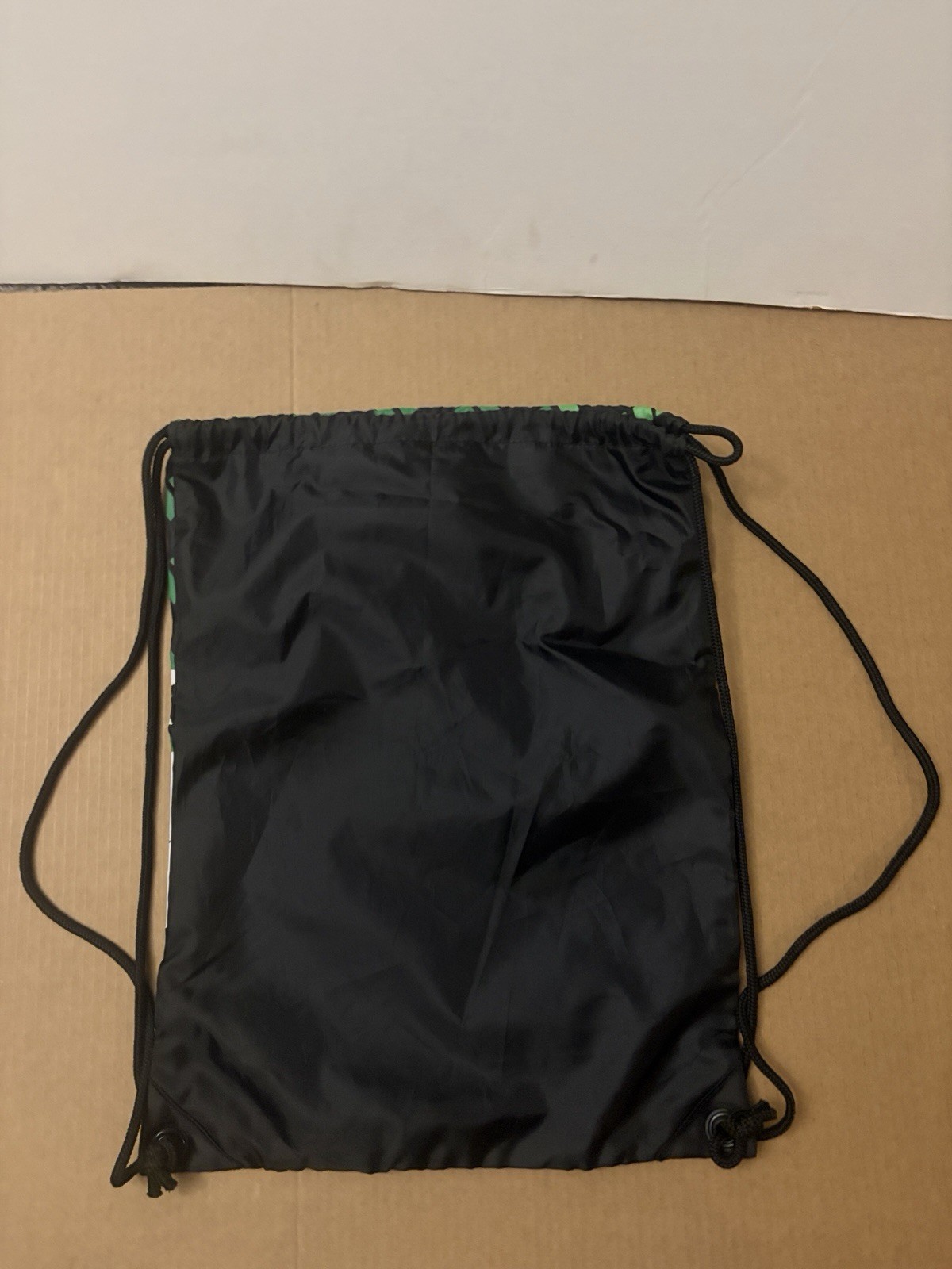 DC skate brand Simpski drawstring green with black and white dc logo backpack