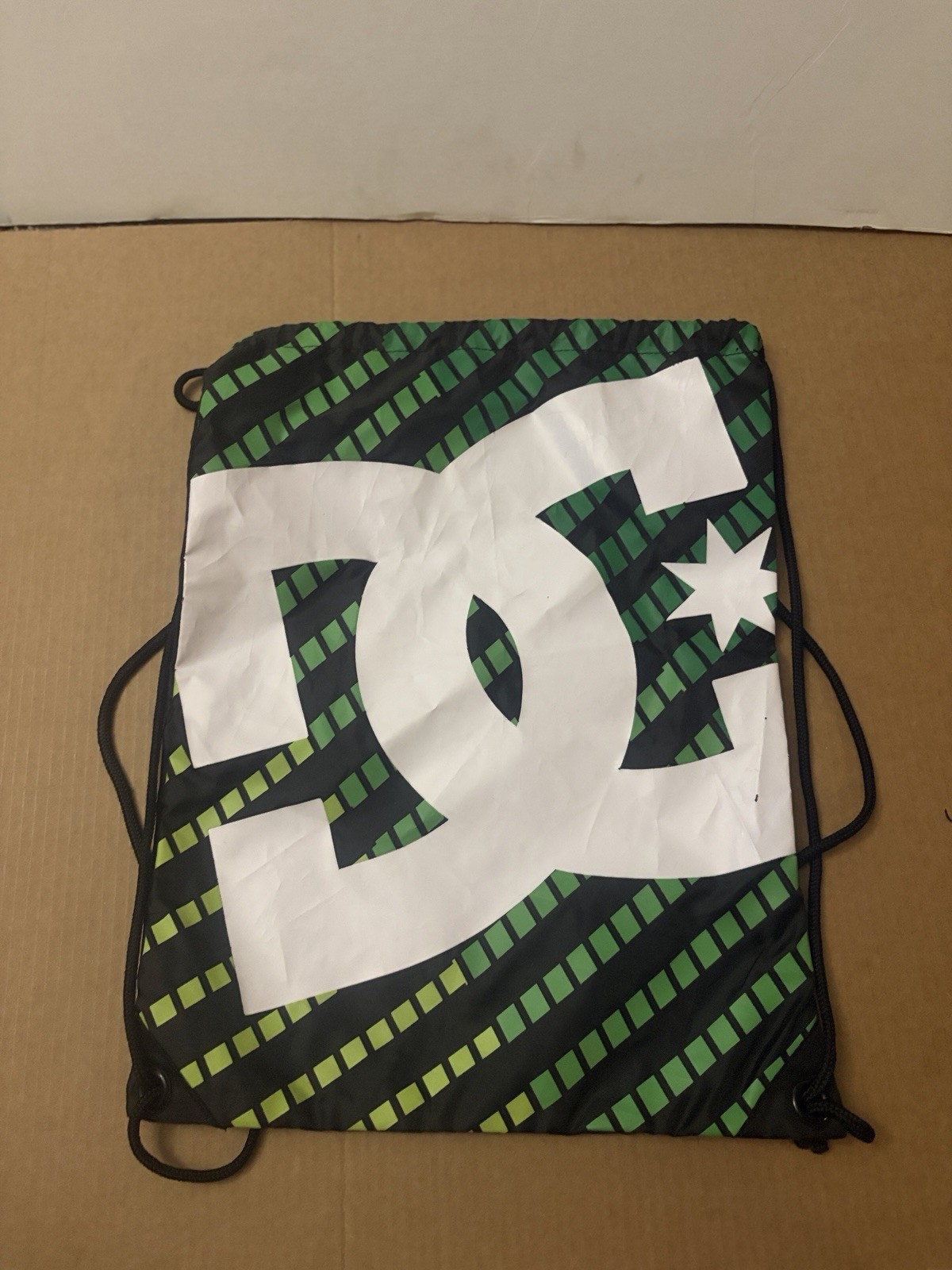DC skate brand Simpski drawstring green with black and white dc logo backpack