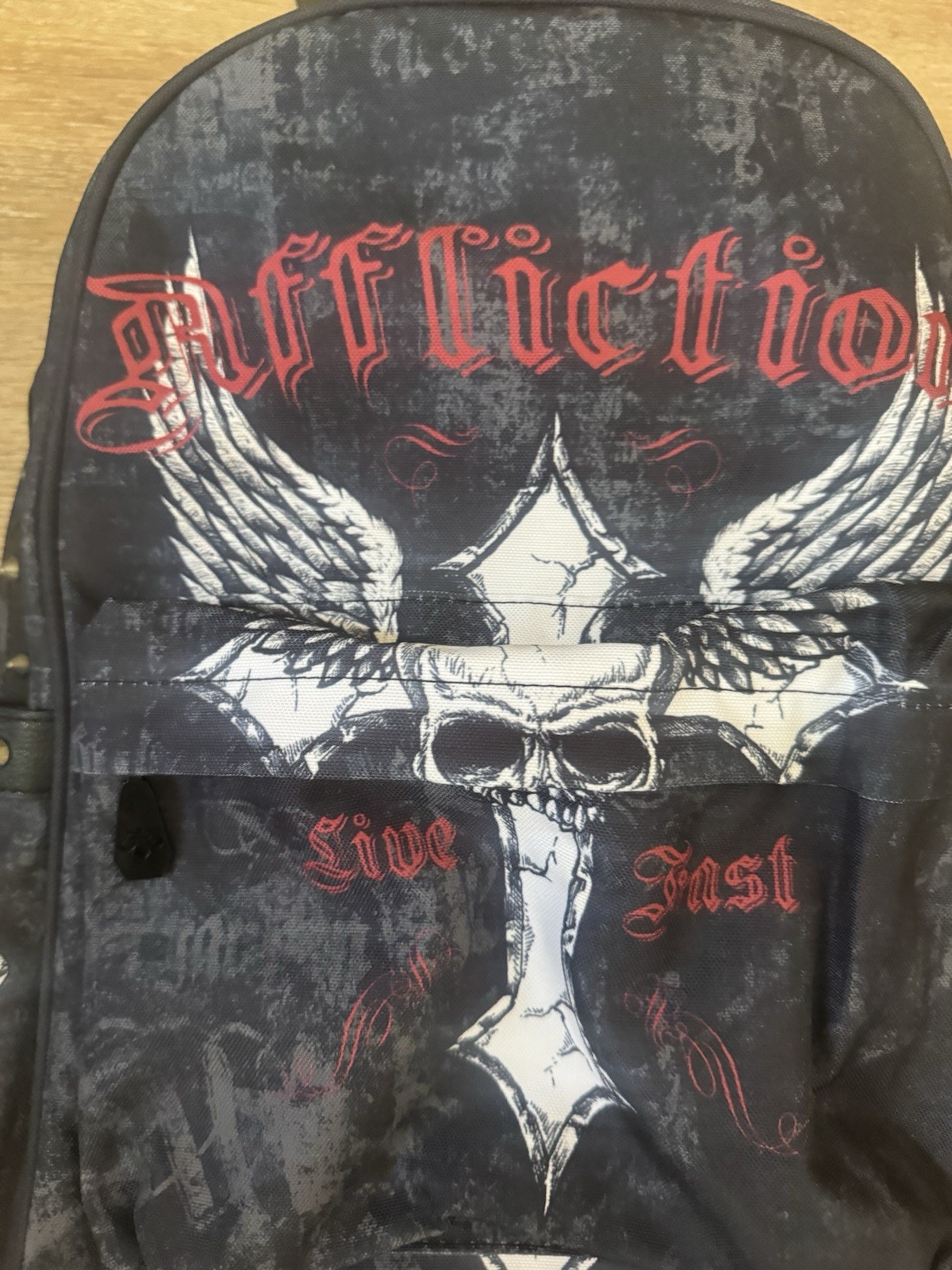 RARE Affliction black & navy backpack with white & red skull with wings graphic