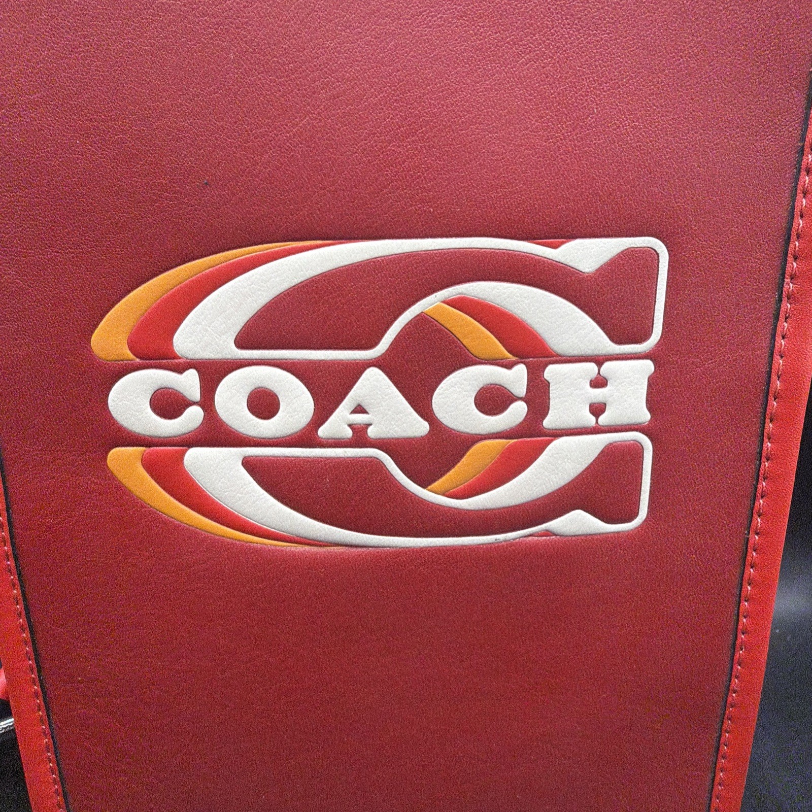 COACH Track Sling Backpack in Colorblock with Stamp in Red Ivory Orange