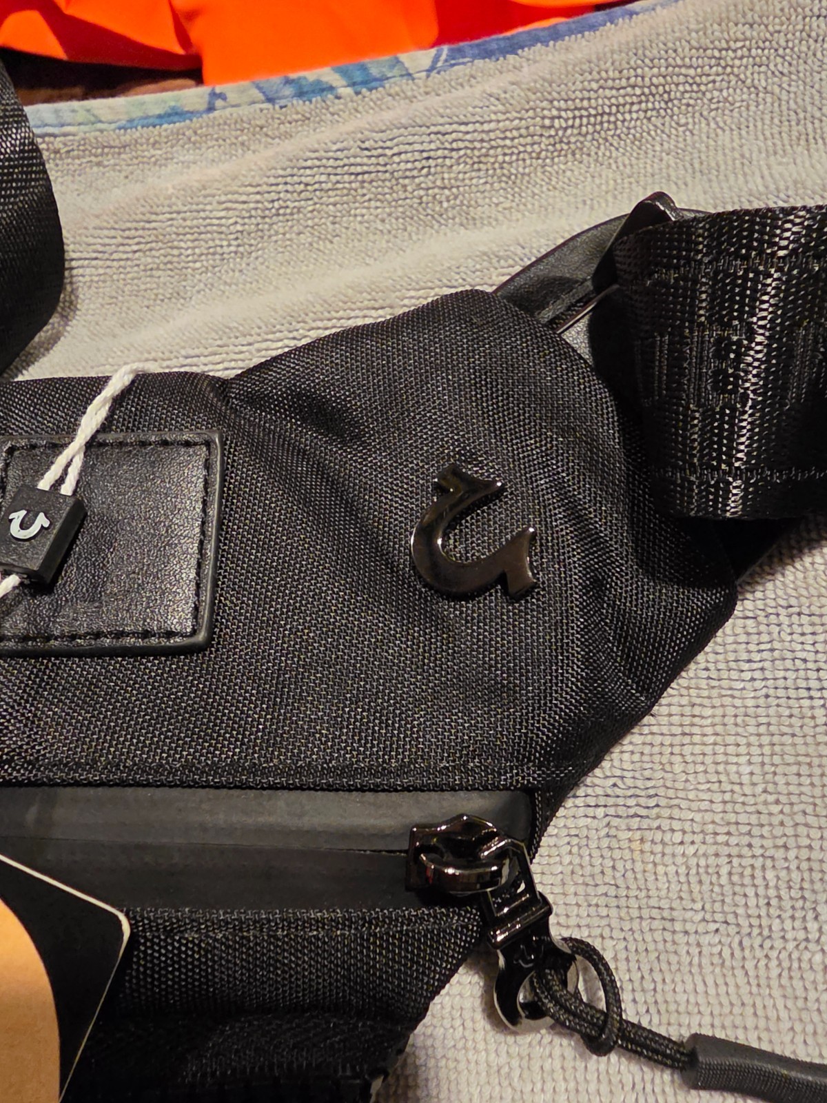 True Religion black Triangular Sling crossbody bag unisex. NWT