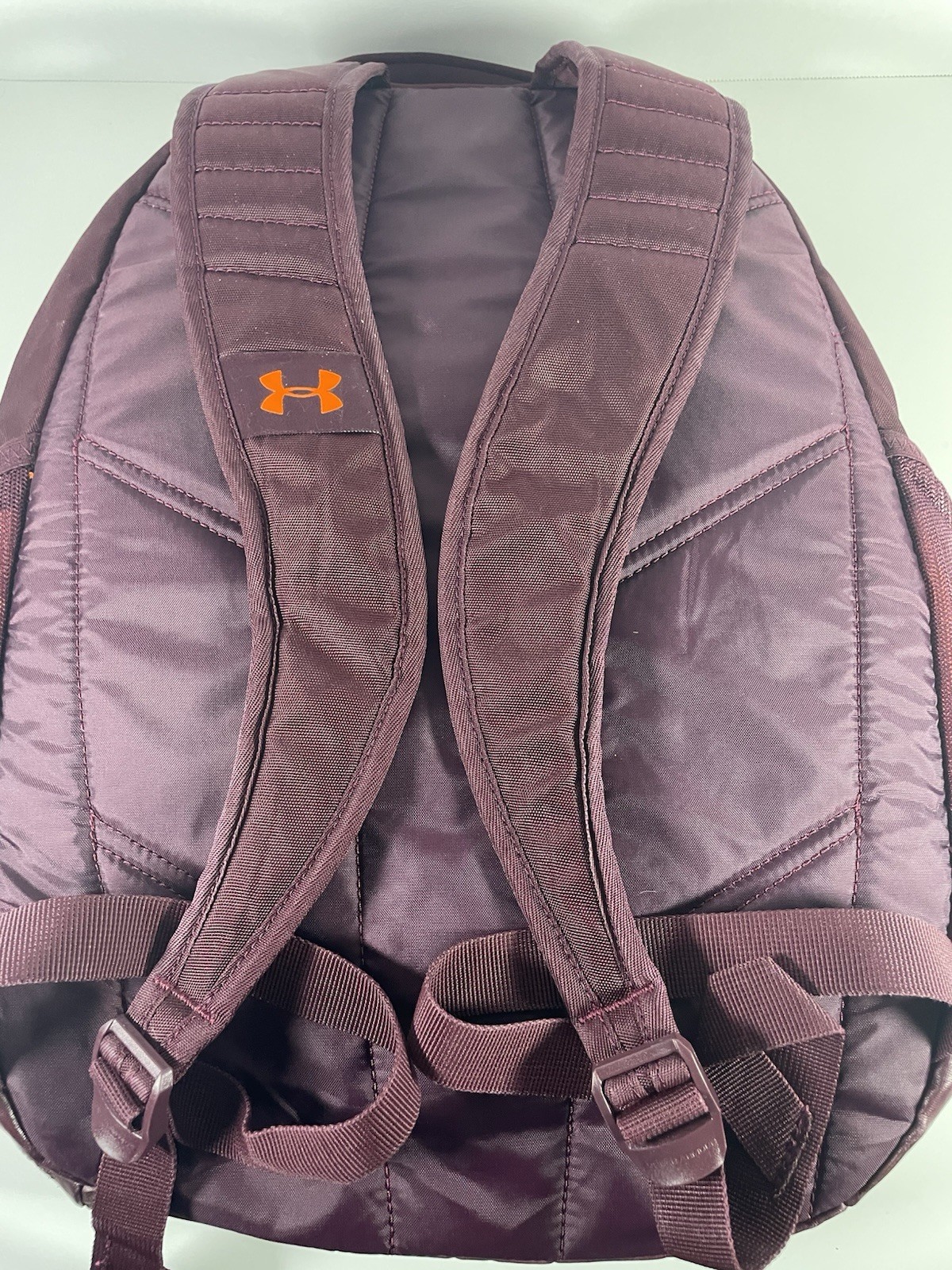 Under Armour Hustle 3.0 Backpack in the Dark Maroon and Orange colorway.