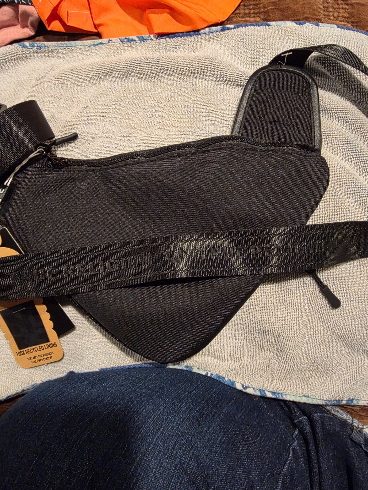 True Religion black Triangular Sling crossbody bag unisex. NWT