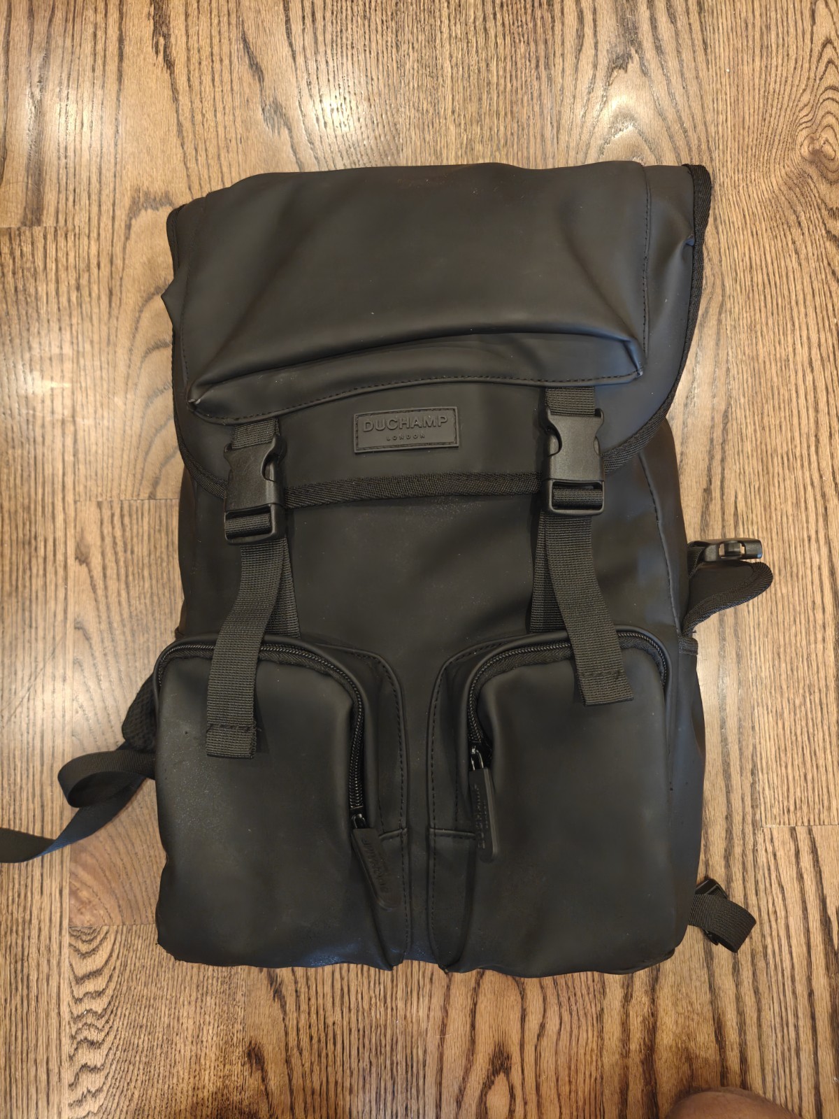 Duchamp London Flapover Laptop Backpack Black Buckle Drawstring Zip Pockets