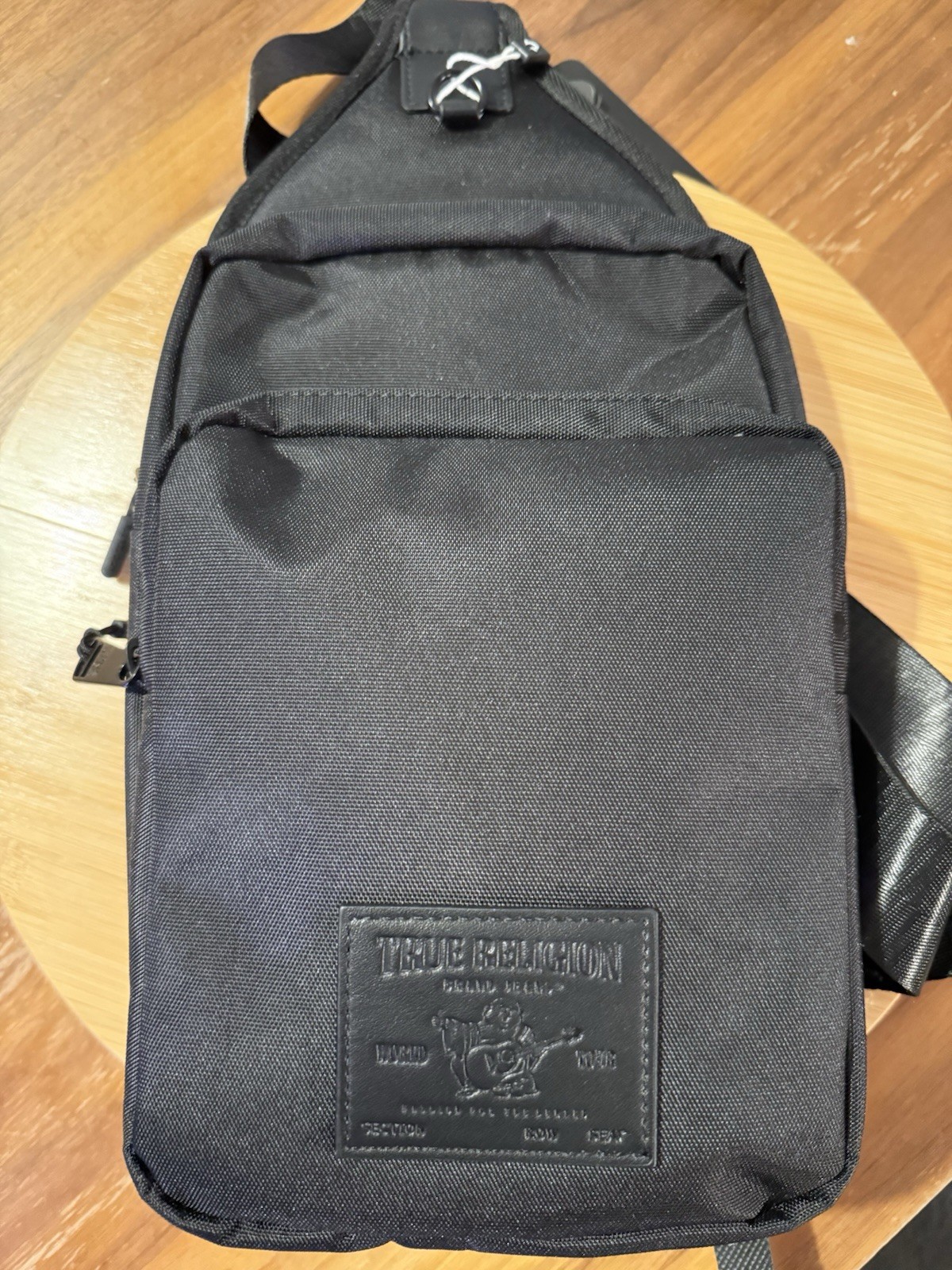 True Religion Black Small Crossbody Sling Bag w/ Outer Pockets, Zip Closure