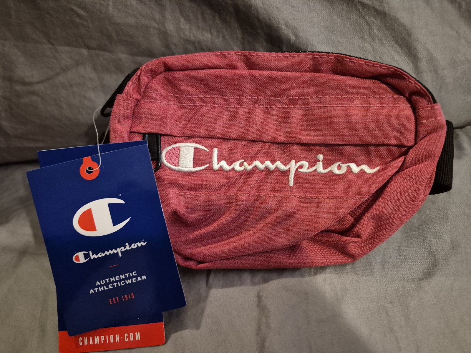 A brand new with tags Champion small sized fanny pack one size fits most