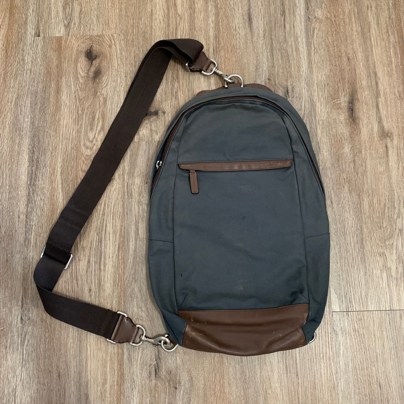 Coach 2013 canvas sling backpack in navy blue w/ brown leather panels – 13x18in