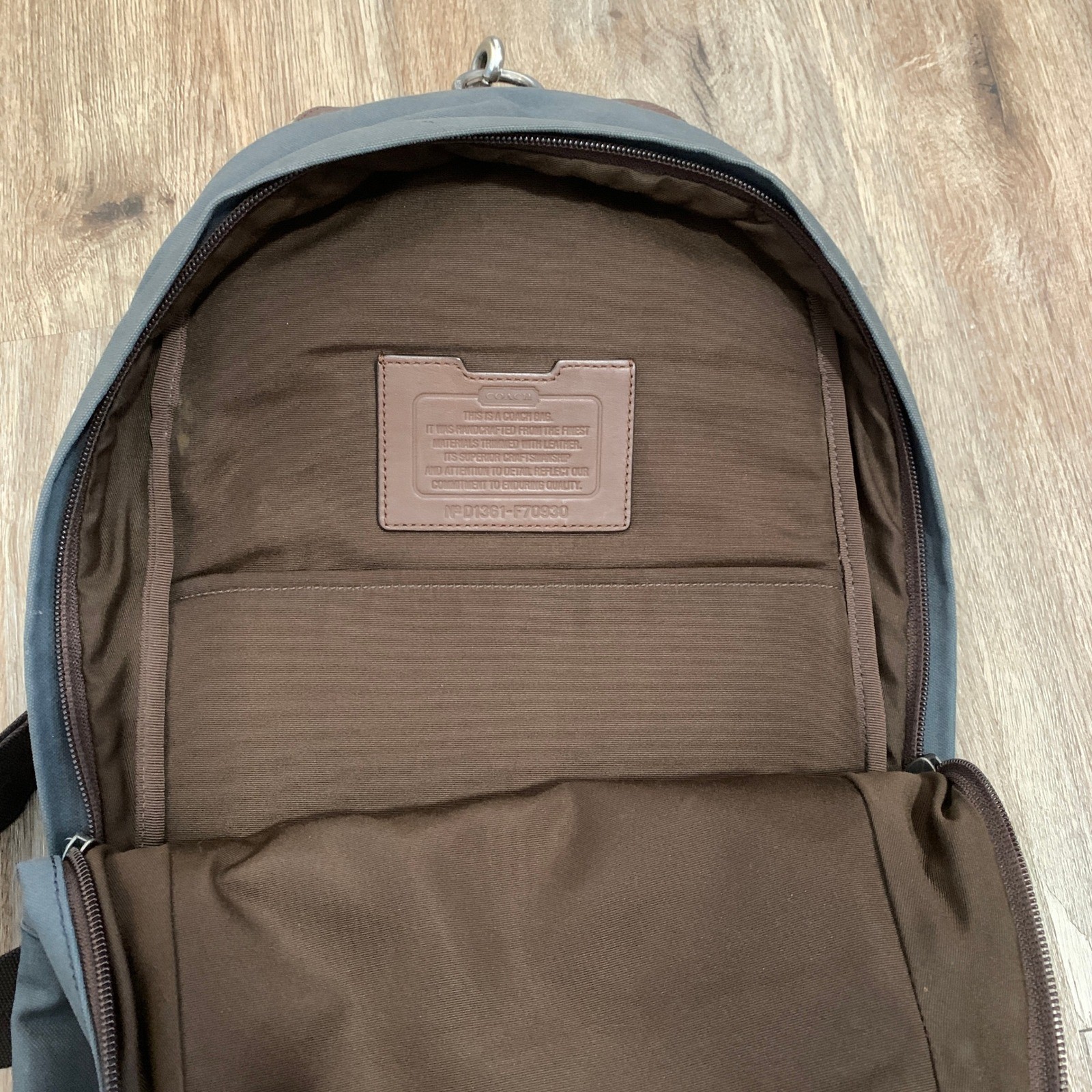 Coach 2013 canvas sling backpack in navy blue w/ brown leather panels – 13x18in