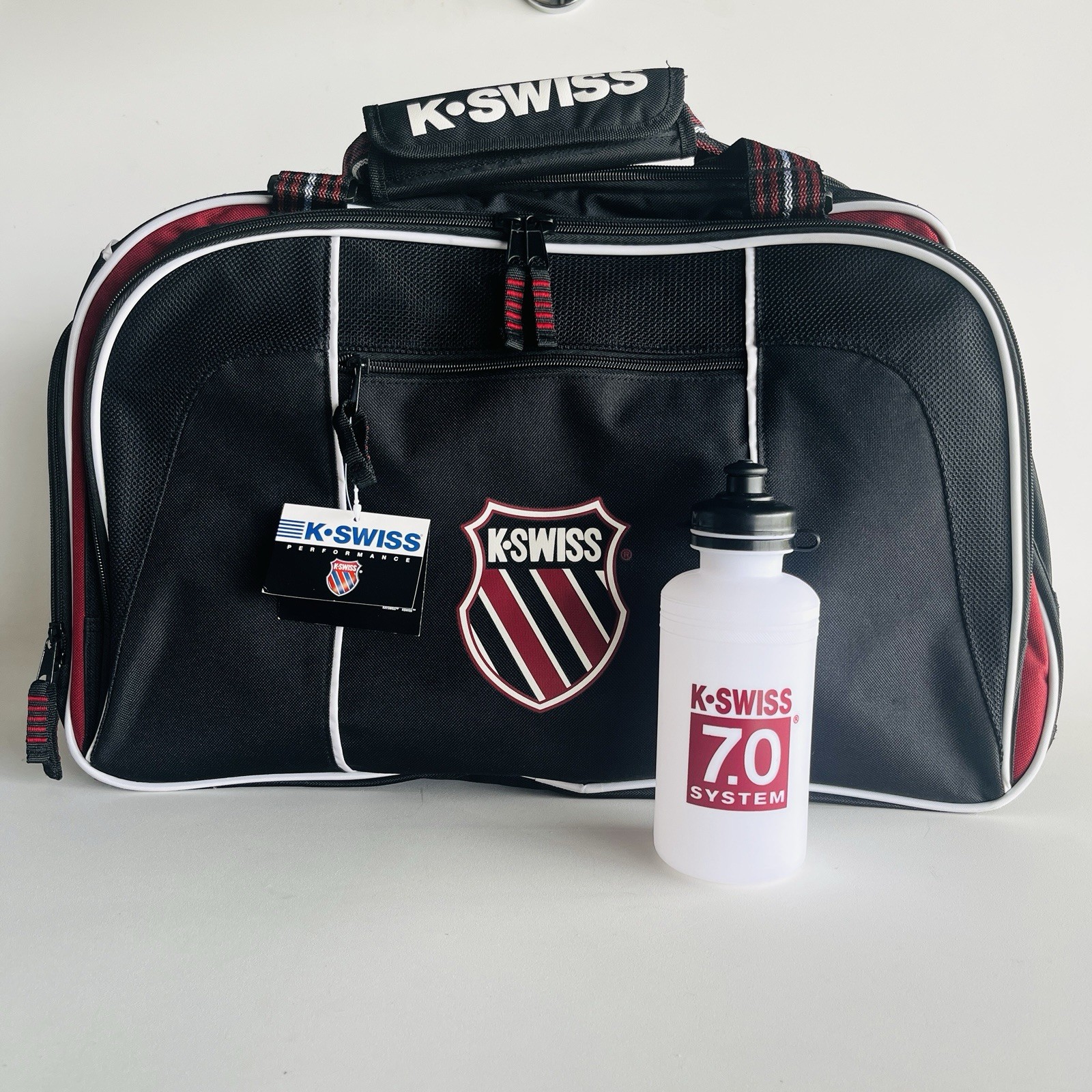 K-SWISS – Reinforcement Sports Bag 7.0 System – BLK/RED/WHT 22” Bottle Included
