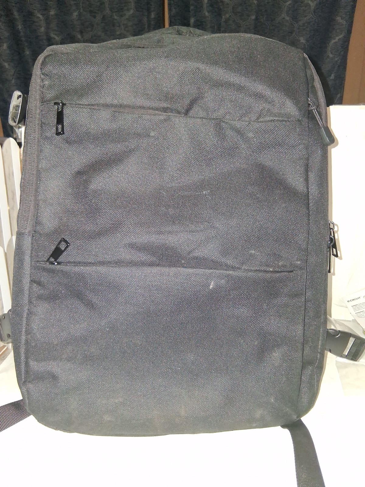 Minimalist, matte black exterior with structured, horizontal compartments.