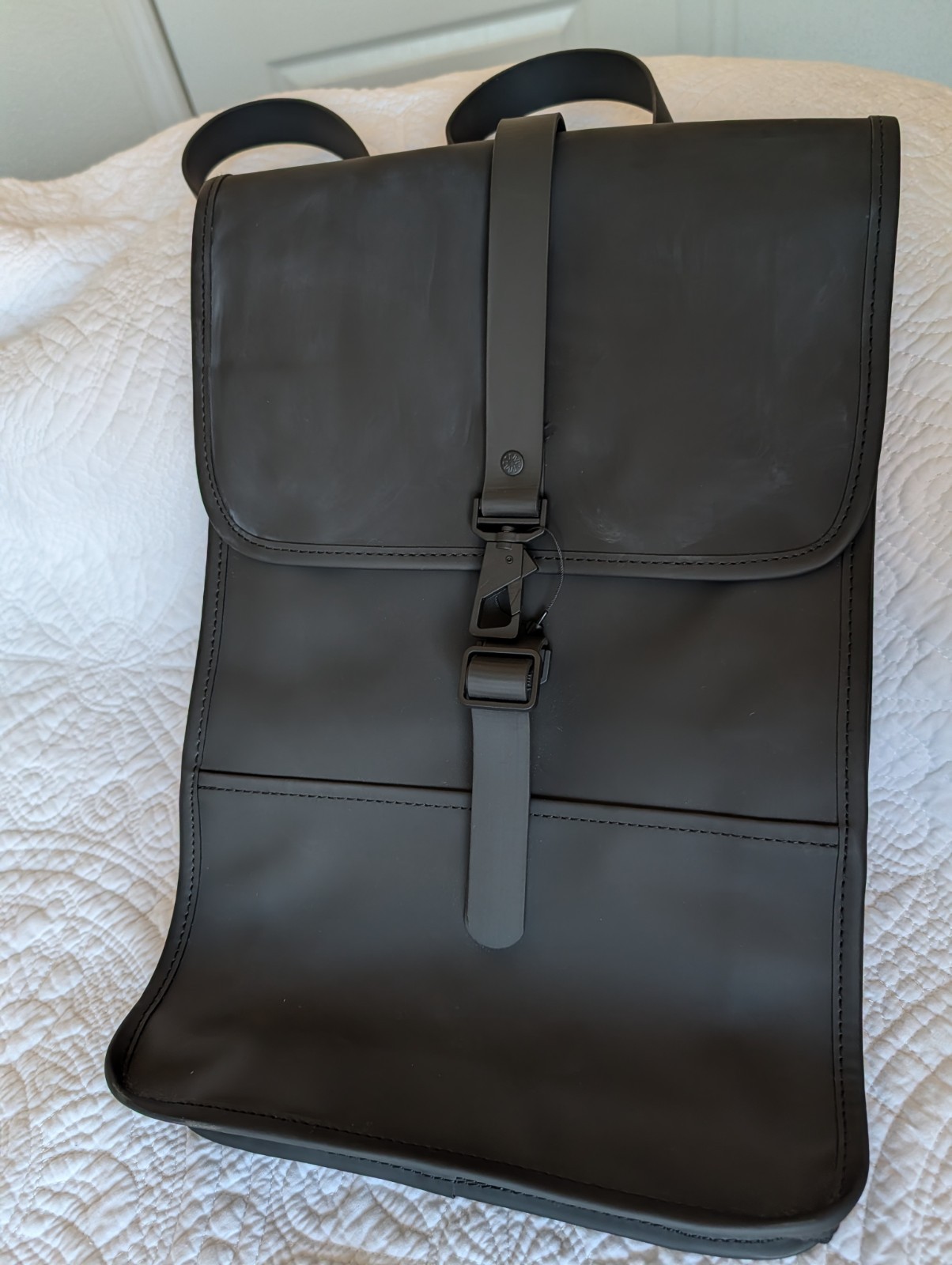 Brand New Rains Backpack in black, made from signature waterproof PU fabric.