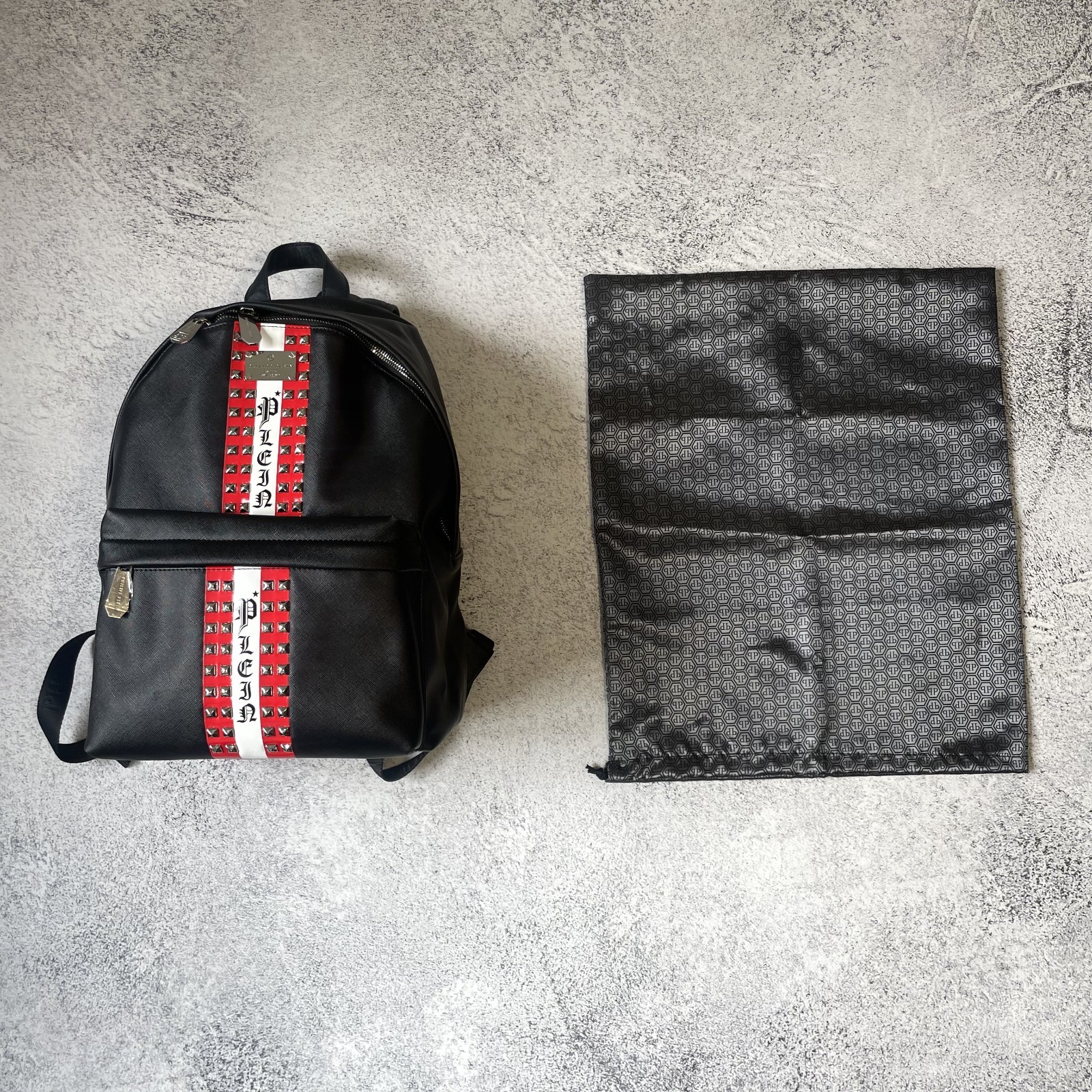 Philipp Plein black backpack, spikes, red center stripe, luxury streetwear SS26.