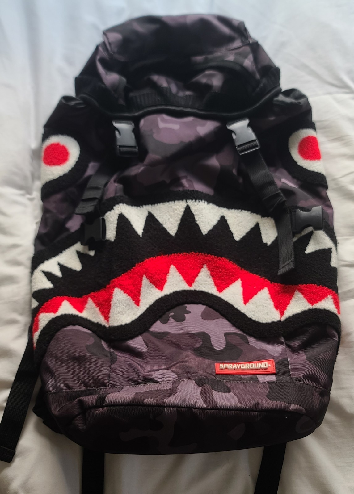 Sprayground Chenille Black Camo Shark Top Loader backpack.