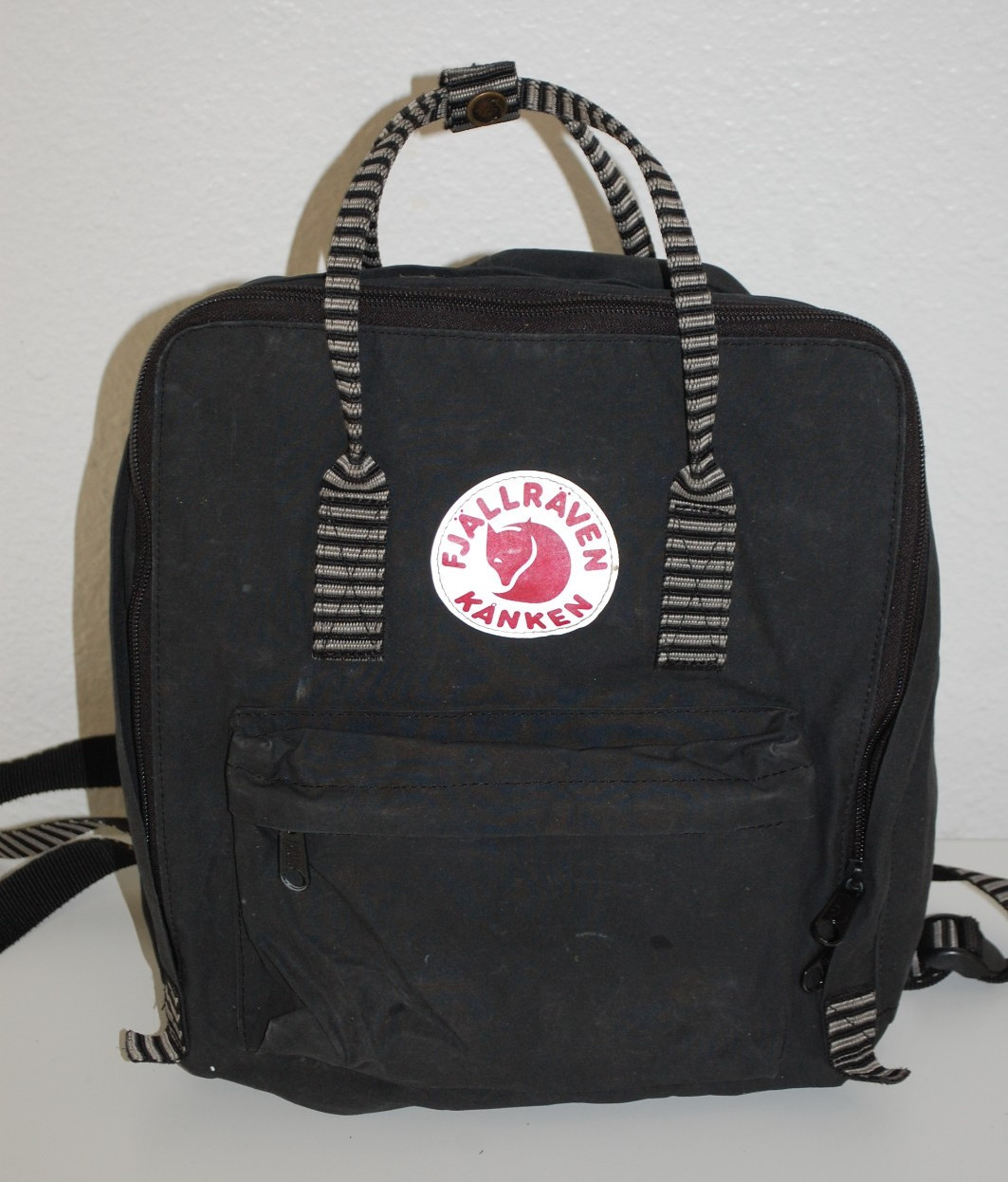 Fjallraven Kanken Backpack in Black w/ Red Logo and Black-White Striped Handles
